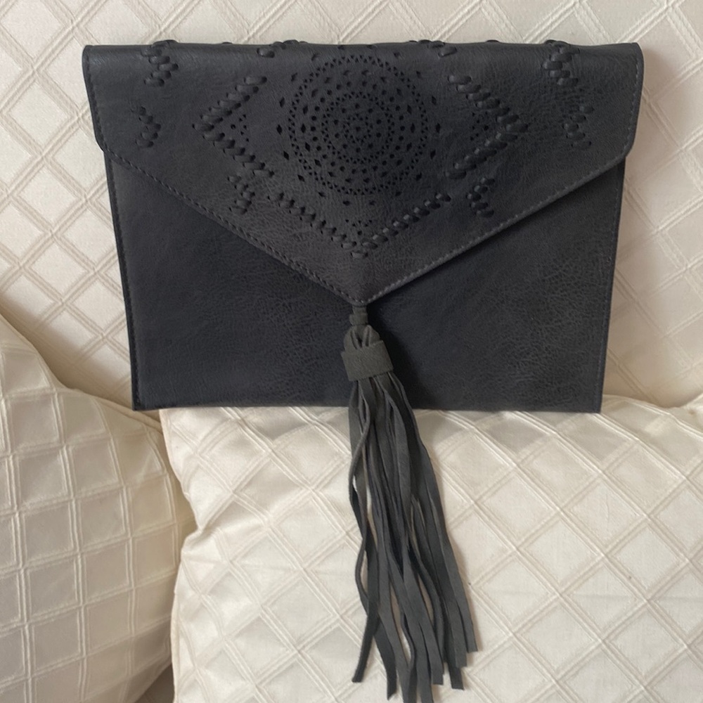 VGUC. Straight level black clutch. Suede tassel in front.